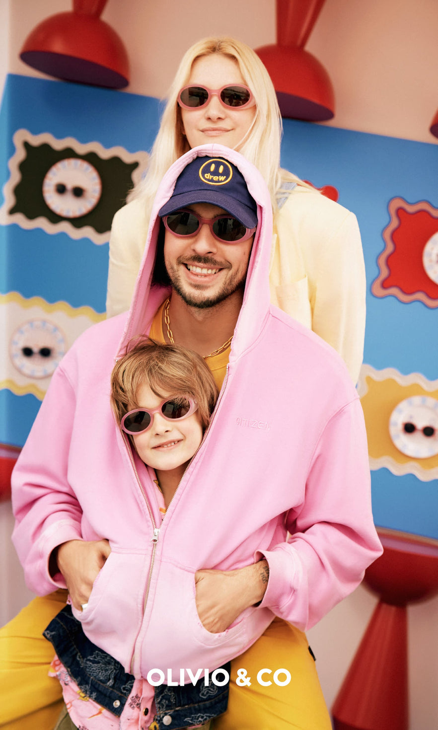 Family of three wearing Olivio & Co sunglasses